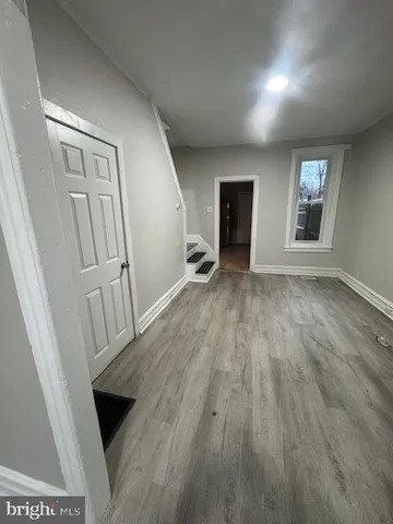 wooden floor in an empty room with a fireplace