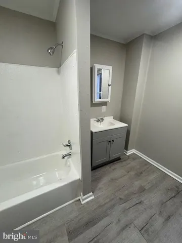 a spacious bathroom with a sink a mirror and a bathtub