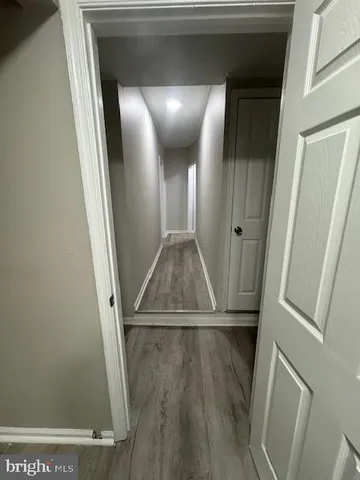 view of a hallway with wooden floor