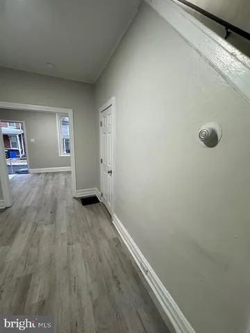 a view of a room with wooden floor