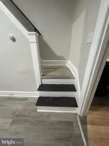 a view of staircase with white walls and a window