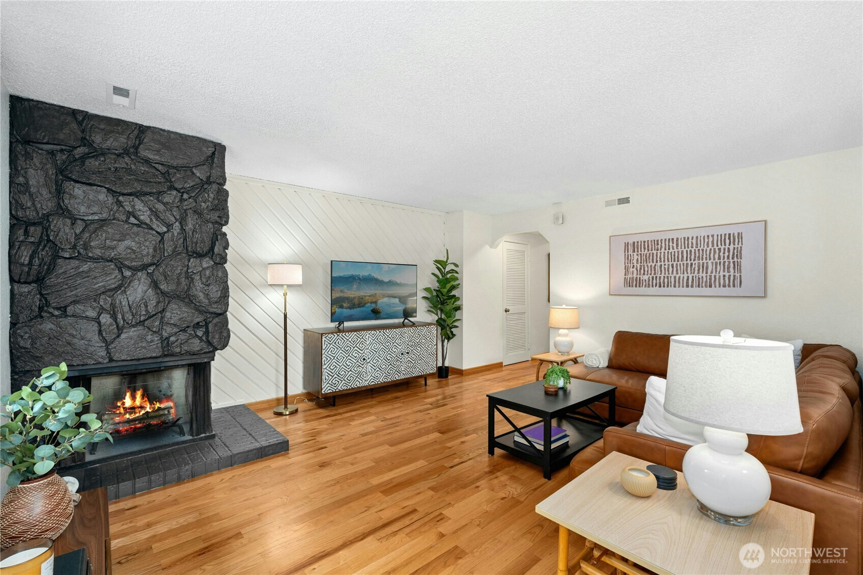 9523 Northeast 180th Street, Unit A102 Bothell, WA 98011 - Photo 4 of 29 a living room with furniture and a fireplace