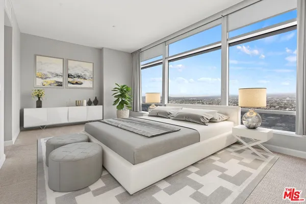 a spacious bedroom with a large bed and a couch