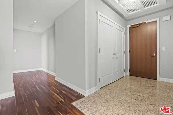 a view of hallway with wooden floor
