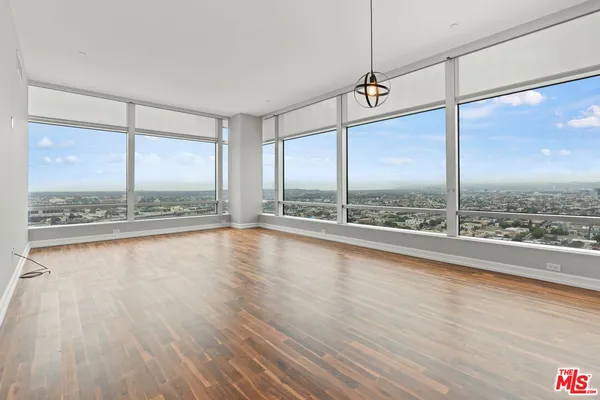 a view of a floor to ceiling window and wooden floor