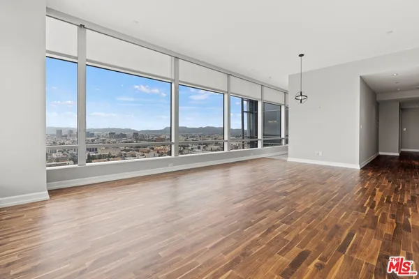 a view of room with window and wooden floor