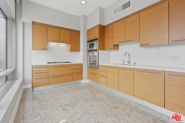 a kitchen with cabinets and window
