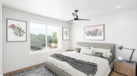 a bedroom with a large bed and a window