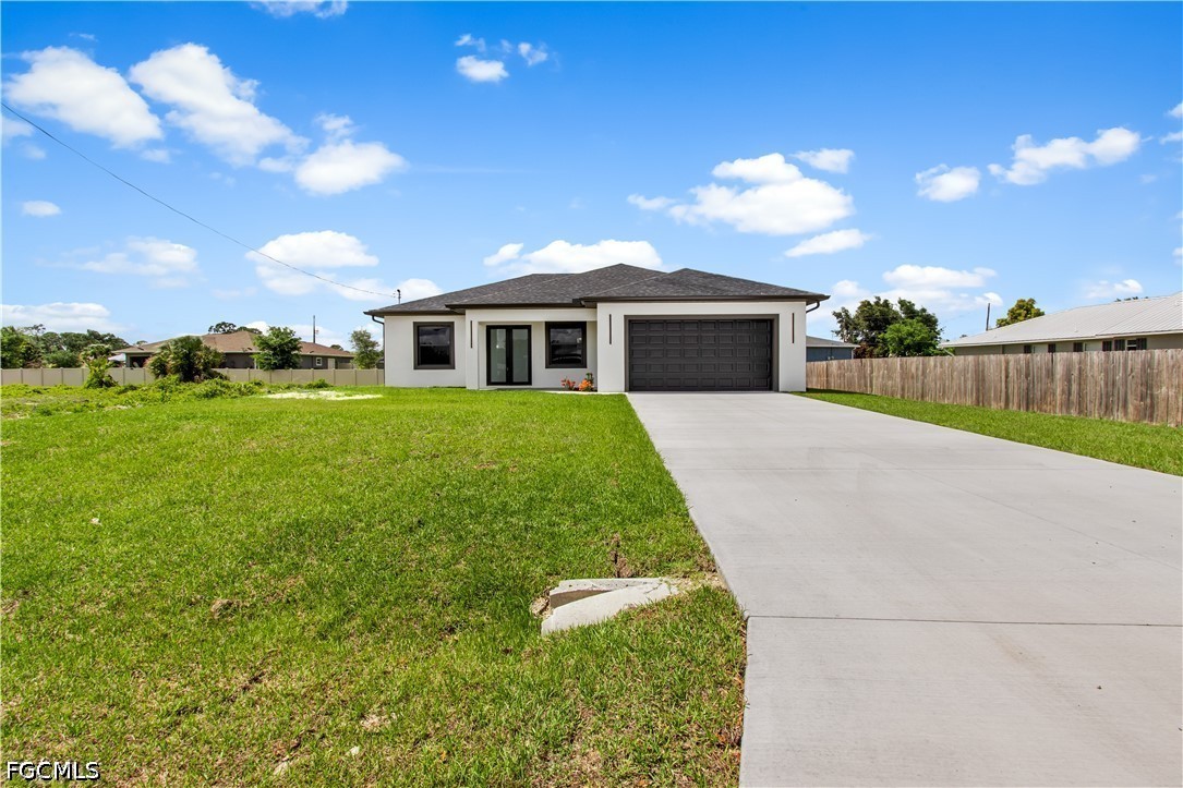 3004 South Tulip Road LaBelle, FL 33935 - Photo 2 of 24 a view of a house with a yard and potted plants