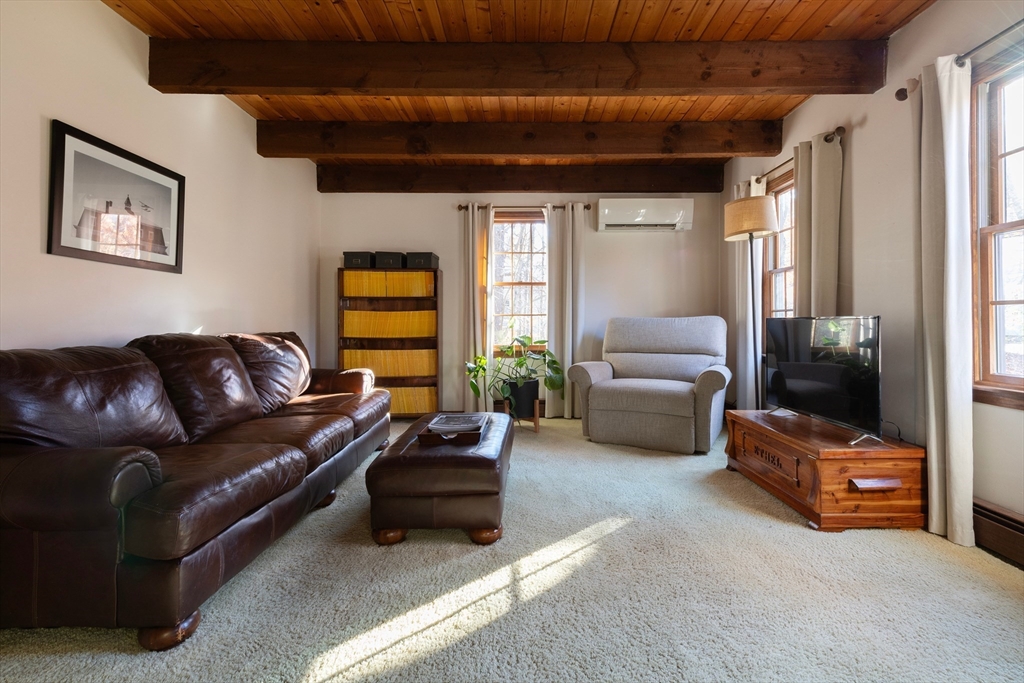 5 June Street Pepperell, MA 01463 - Photo 4 of 31 a living room with furniture and a flat screen tv
