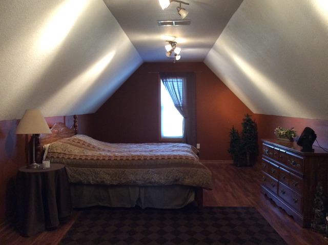 2076 Wiley Ridge Road Kankakee, IL 60901 - Photo 25 of 25 a bed room with a bed dresser and a chandelier