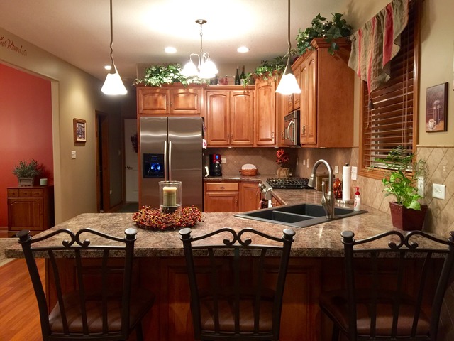 2076 Wiley Ridge Road Kankakee, IL 60901 - Photo 5 of 25 a kitchen with a table chairs stove and refrigerator