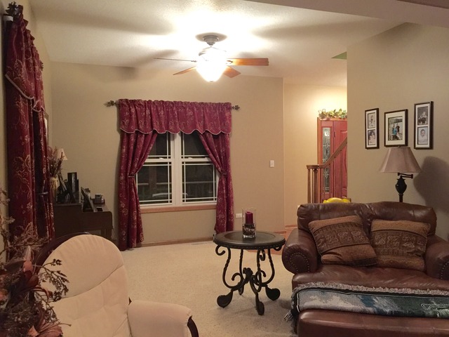 2076 Wiley Ridge Road Kankakee, IL 60901 - Photo 10 of 25 a living room with furniture a chandelier and a mirror