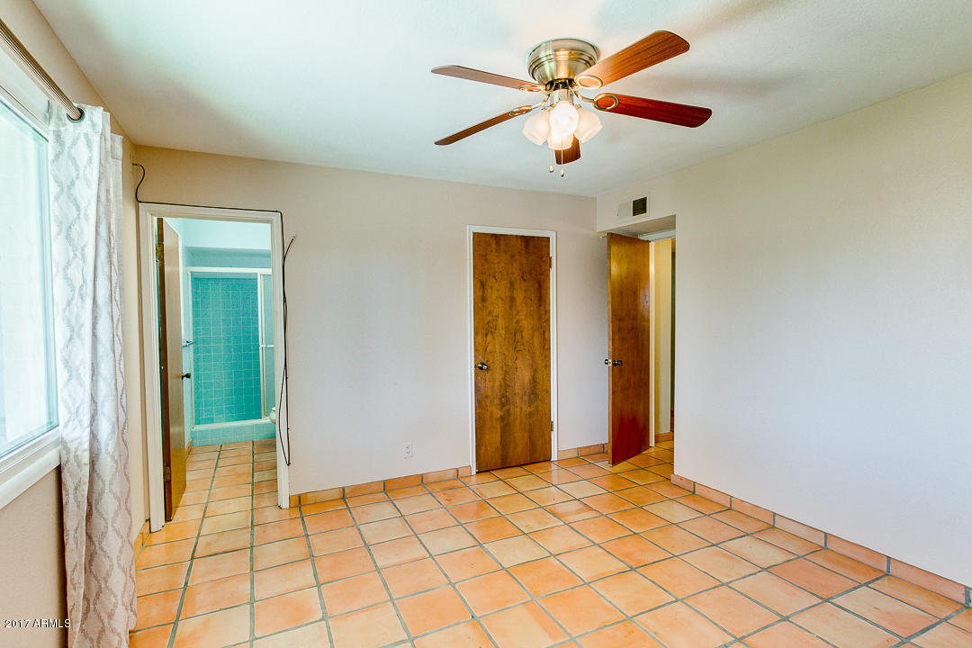 2816 South Evergreen Road Tempe, AZ 85282 - Photo 17 of 38 a view of a hallway with a chandelier fan