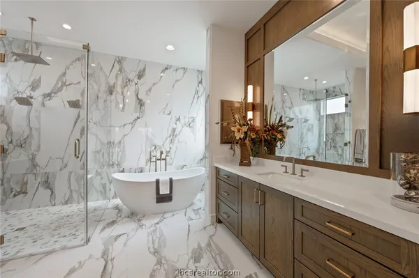 a bathroom with a double vanity sink mirror and shower