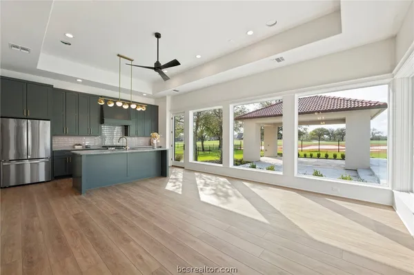 a large kitchen with stainless steel appliances kitchen island a large island in the center