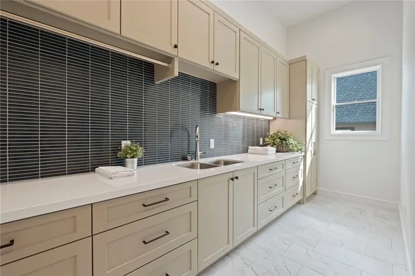 a view of a kitchen with a sink a refrigerator and a stove top oven