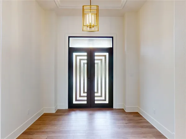 a view of an entryway with wooden floor and door