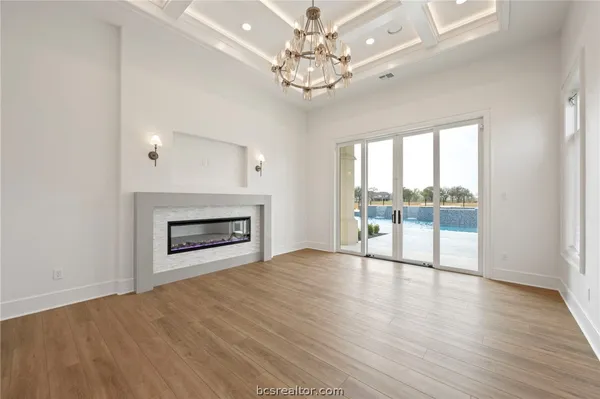 a view of an empty room with a fireplace and a window