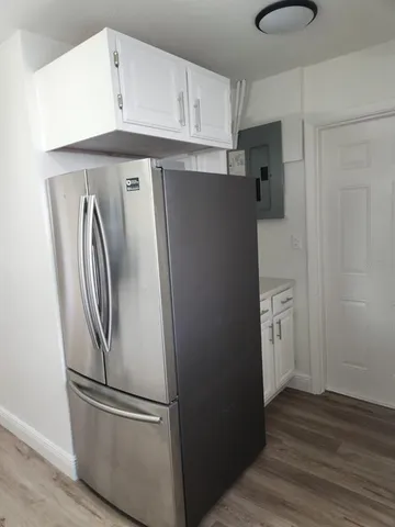 a kitchen with stainless steel appliances granite countertop a refrigerator and a sink