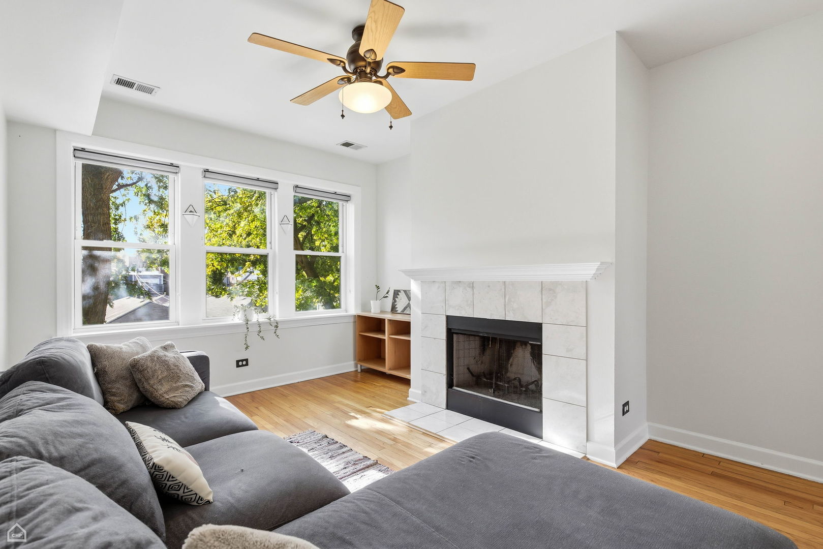 3222 West Berteau Avenue, Unit 2 Chicago, IL 60618 - Photo 2 of 16 a living room with furniture and a fireplace