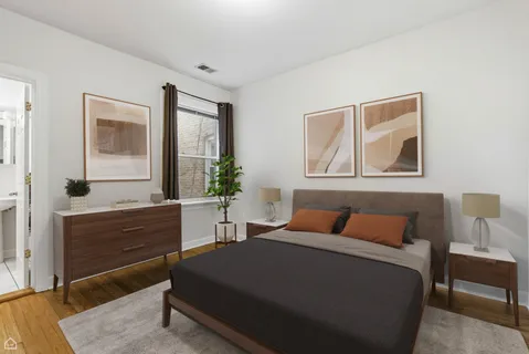 a bedroom with a bed and a dresser