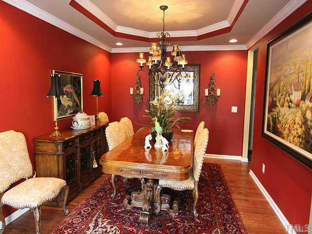 6105 Schaller Court Raleigh, NC 27617 - Photo 1 of 23 This elegant dining room features a tray ceiling, wide hickory flooring, crown molding, and a view out to the courtyard. Dining Room