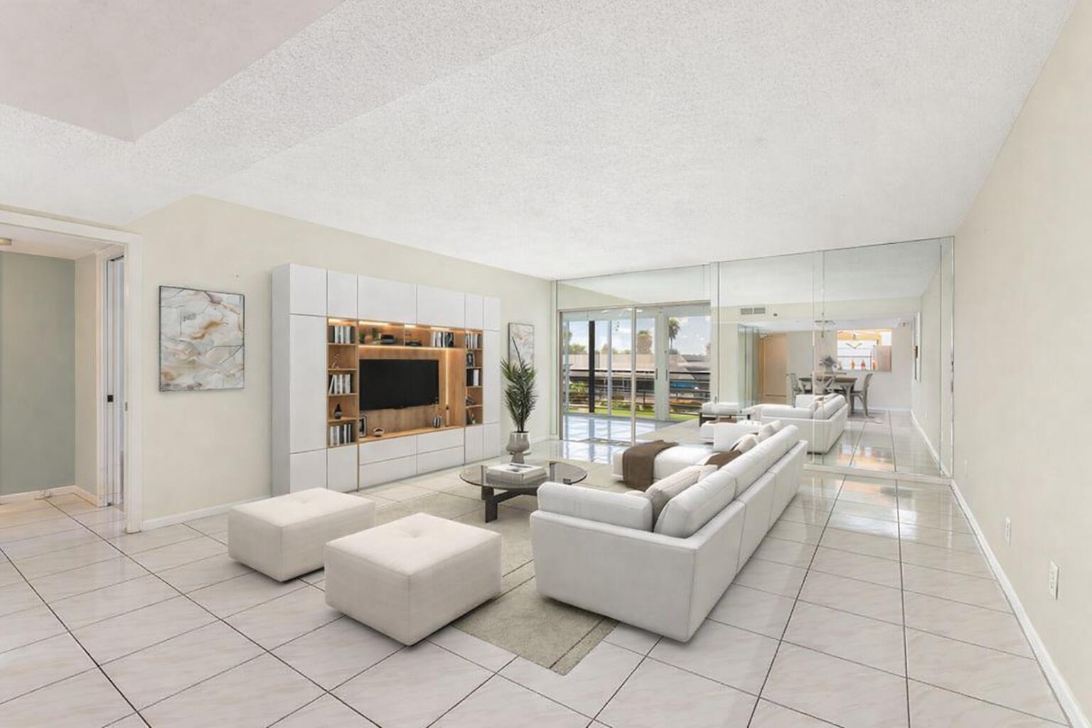 9220 Southwest 14th Street, Unit 3208 Boca Raton, FL 33428 - Photo 3 of 43 a living room with furniture and a flat screen tv