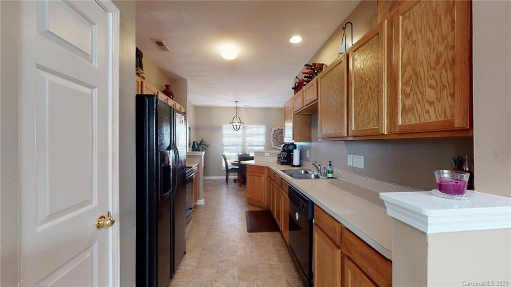 844 Dillard Road Rock Hill, SC 29730 - Photo 17 of 33 a kitchen with stainless steel appliances granite countertop a refrigerator a sink dishwasher and a stove with wooden cabinets