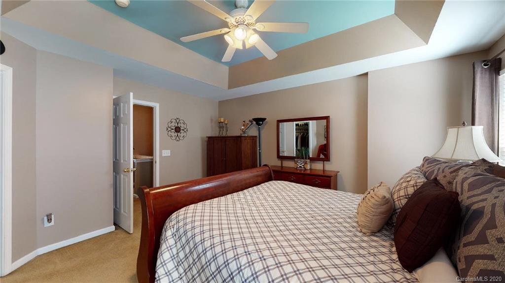844 Dillard Road Rock Hill, SC 29730 - Photo 24 of 33 a bedroom with a bed and a chandelier