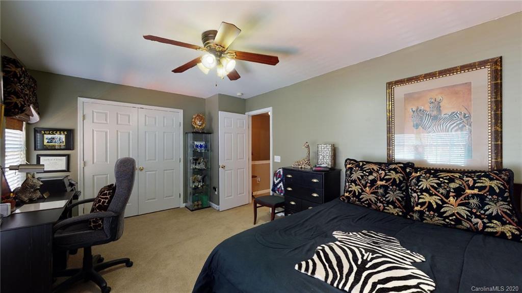 844 Dillard Road Rock Hill, SC 29730 - Photo 30 of 33 a bedroom with a bed and a chandelier