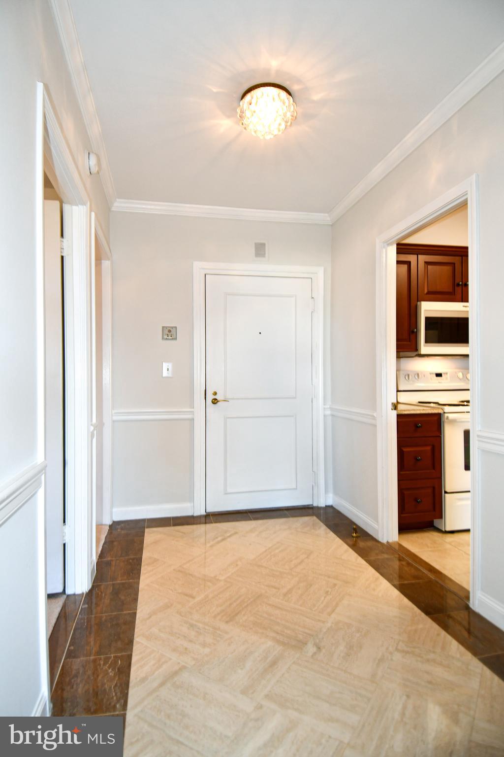 1250 South Washington Street, Unit 816 Alexandria, VA 22314 - Photo 13 of 58 a view of an empty room with a kitchen