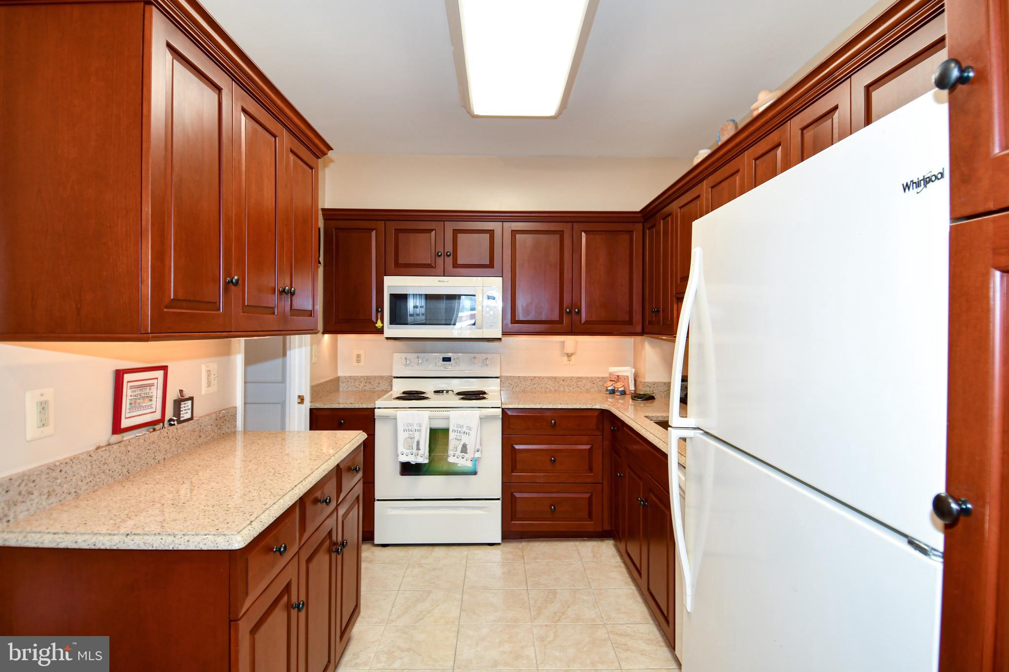1250 South Washington Street, Unit 816 Alexandria, VA 22314 - Photo 15 of 58 a kitchen with stainless steel appliances granite countertop a refrigerator sink stove microwave and cabinets