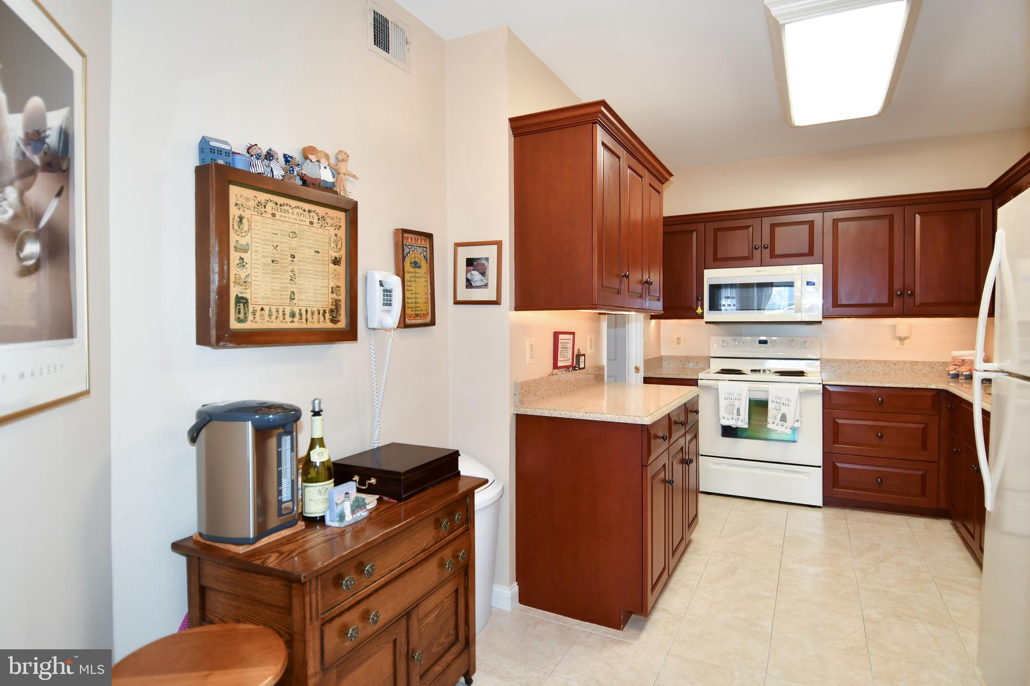 1250 South Washington Street, Unit 816 Alexandria, VA 22314 - Photo 17 of 58 a kitchen with stainless steel appliances granite countertop a stove top oven a sink dishwasher and cabinets with wooden floor