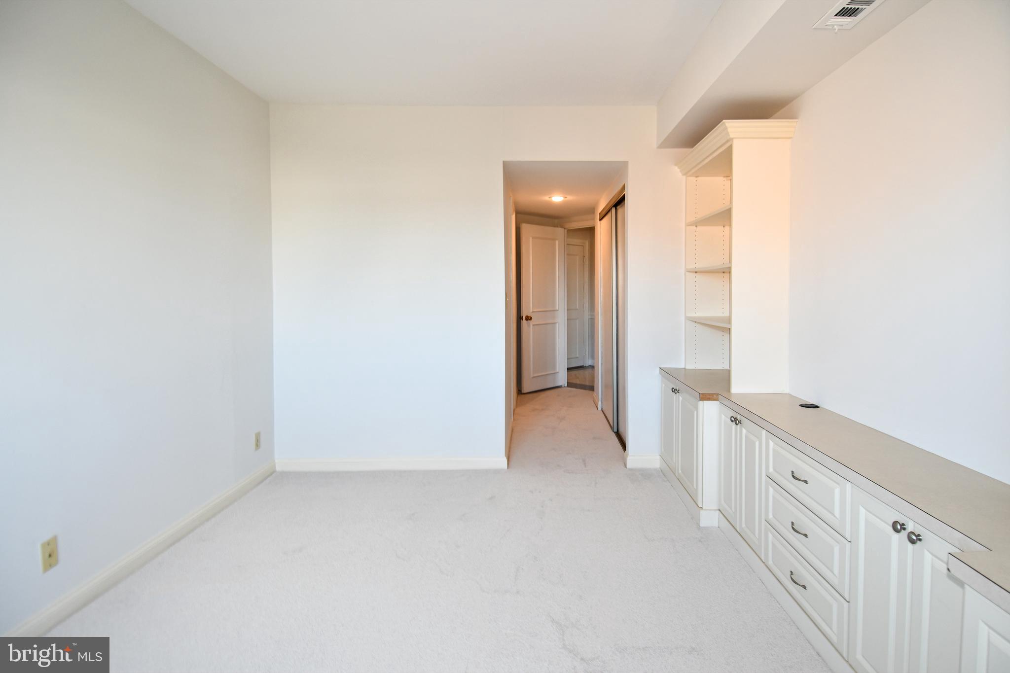 1250 South Washington Street, Unit 816 Alexandria, VA 22314 - Photo 28 of 58 a view of a hallway with white walls