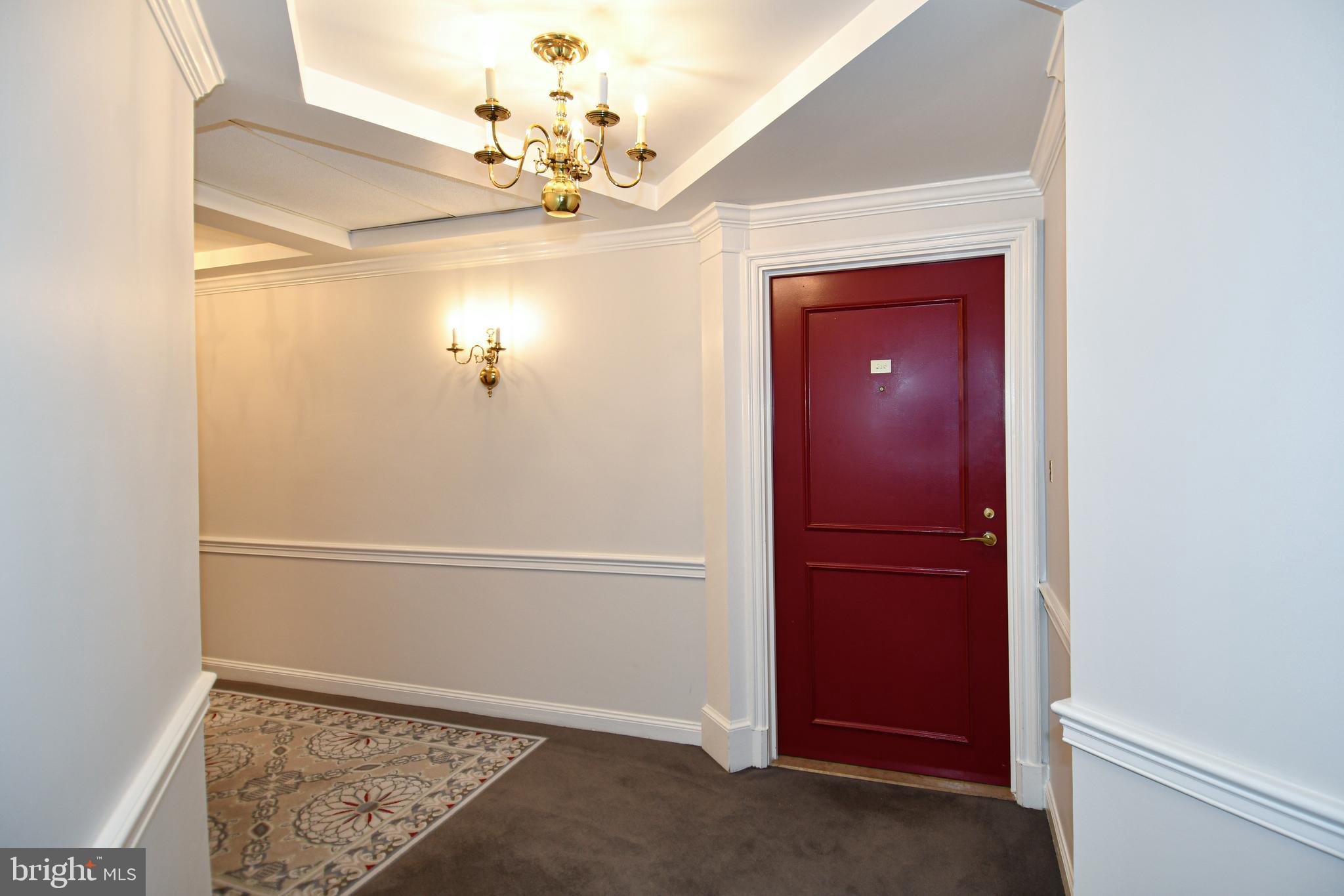 1250 South Washington Street, Unit 816 Alexandria, VA 22314 - Photo 31 of 58 a view of a hallway with a large mirror and a fan