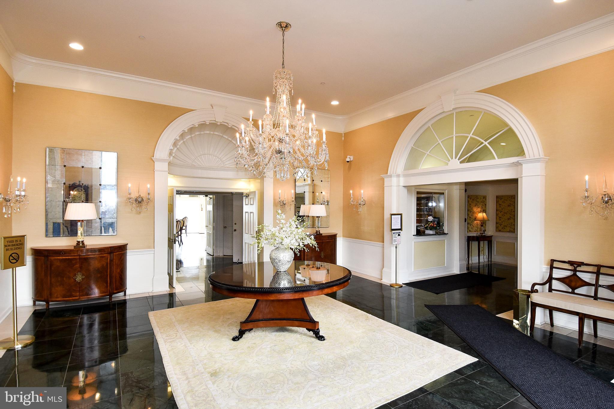 1250 South Washington Street, Unit 816 Alexandria, VA 22314 - Photo 39 of 58 a living room with fireplace furniture and a chandelier