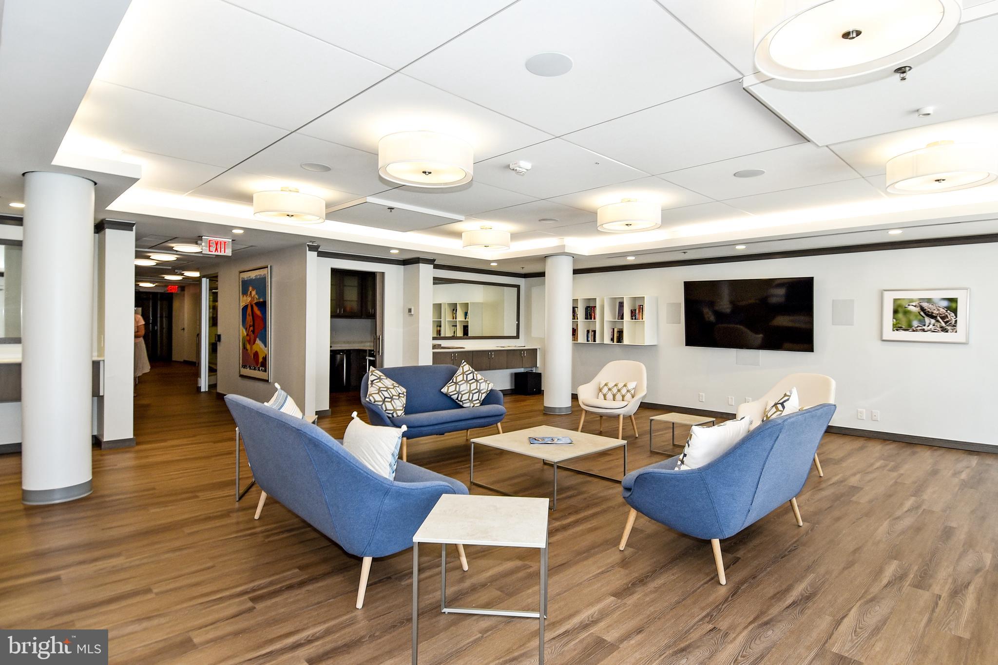 1250 South Washington Street, Unit 816 Alexandria, VA 22314 - Photo 53 of 58 a living room with furniture a flat screen tv and kitchen view