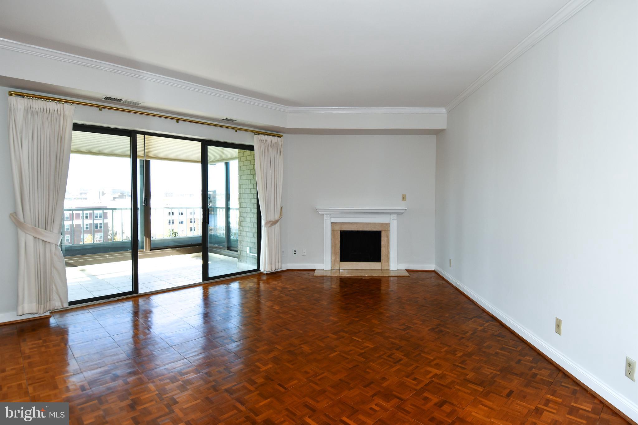 1250 South Washington Street, Unit 816 Alexandria, VA 22314 - Photo 10 of 58 a view of an empty room with wooden floor and a window