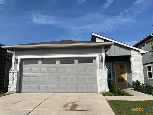 a front view of a house with garage