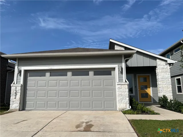 a front view of a house with garage