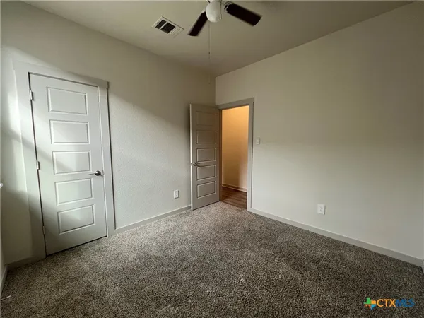 an empty room with fan