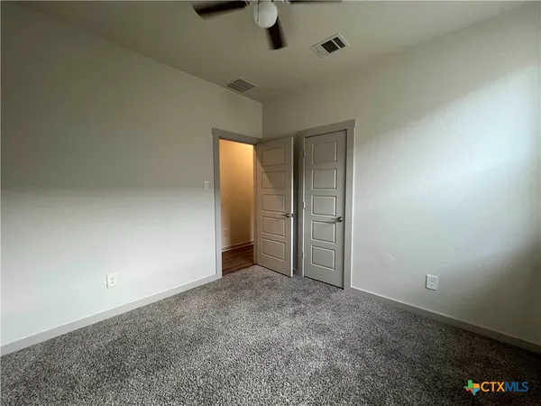 an empty room with a empty space and windows