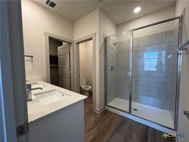 a bathroom with a shower and a sink