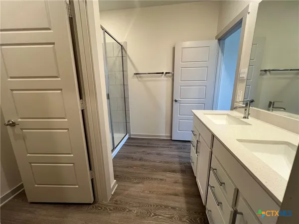 a bathroom with a sink a toilet and a shower