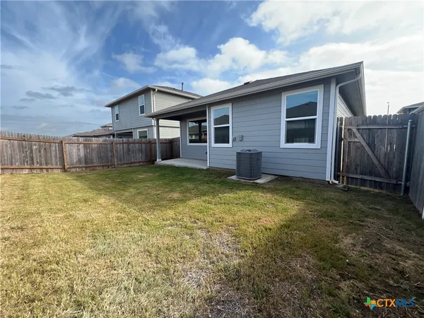 a view of a house with a backyard