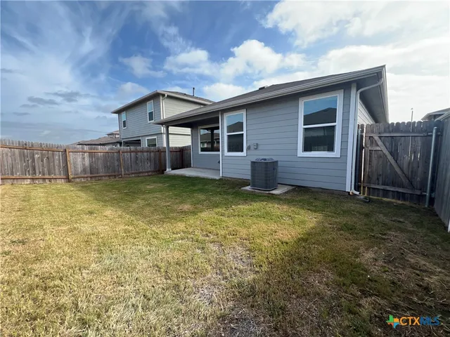 a view of a house with a backyard