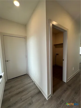 an empty room with wooden floor and closet
