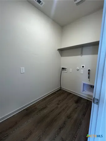 an empty room with wooden floor