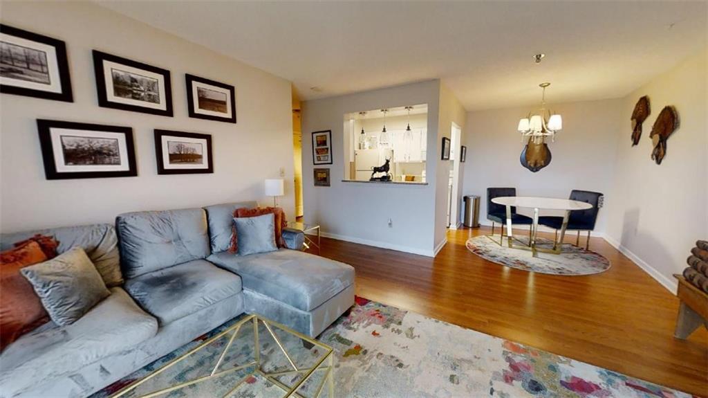 300 Johnson Ferry Road, Unit B605 Atlanta, GA 30328 - Photo 13 of 33 a living room with furniture and wooden floor